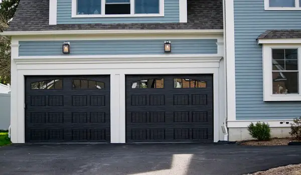 wood accents black garage door white house