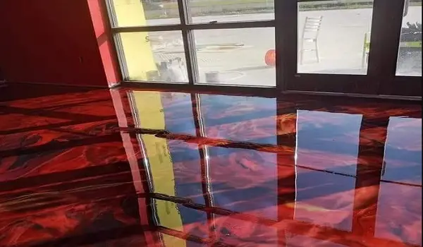 applying red and black epoxy floor paint